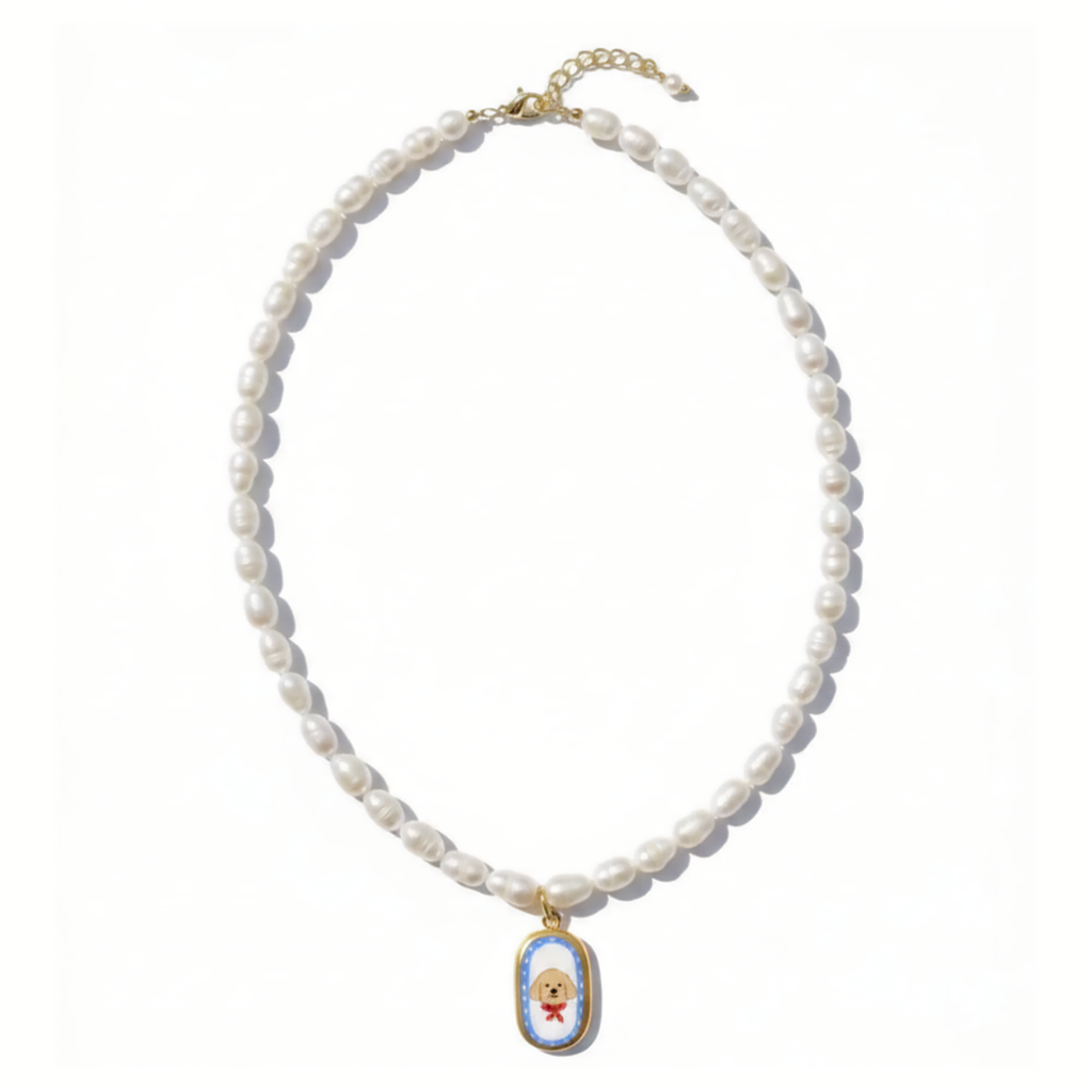 Pearl necklace with a decorative golden retriever pendant on a white background